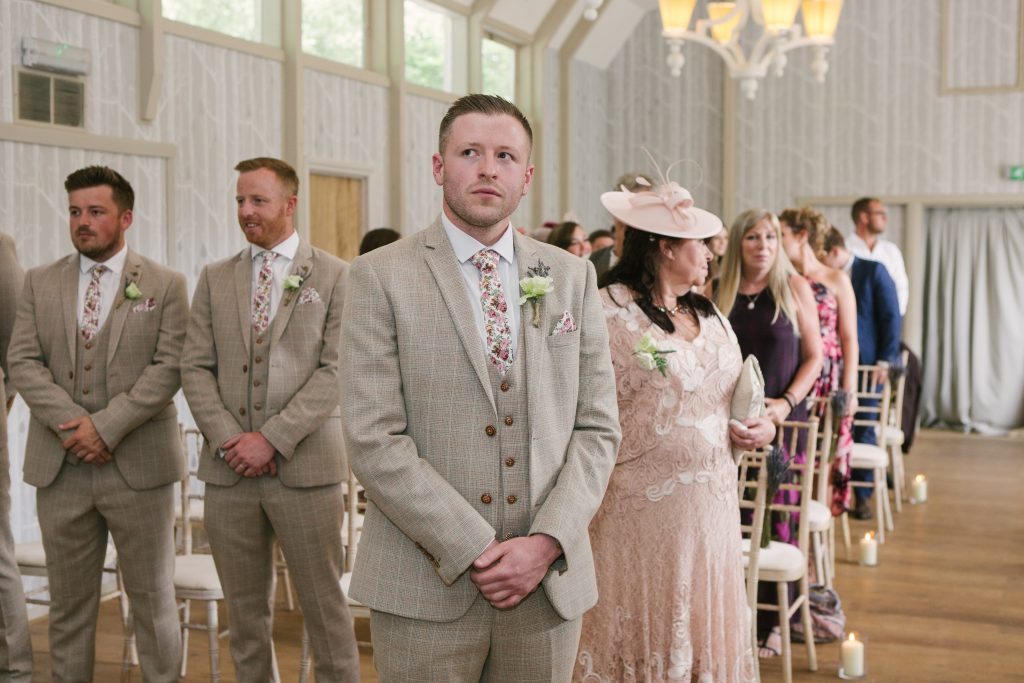 Groom waiting for his Bride to walk down the aisle at Hampton Manor