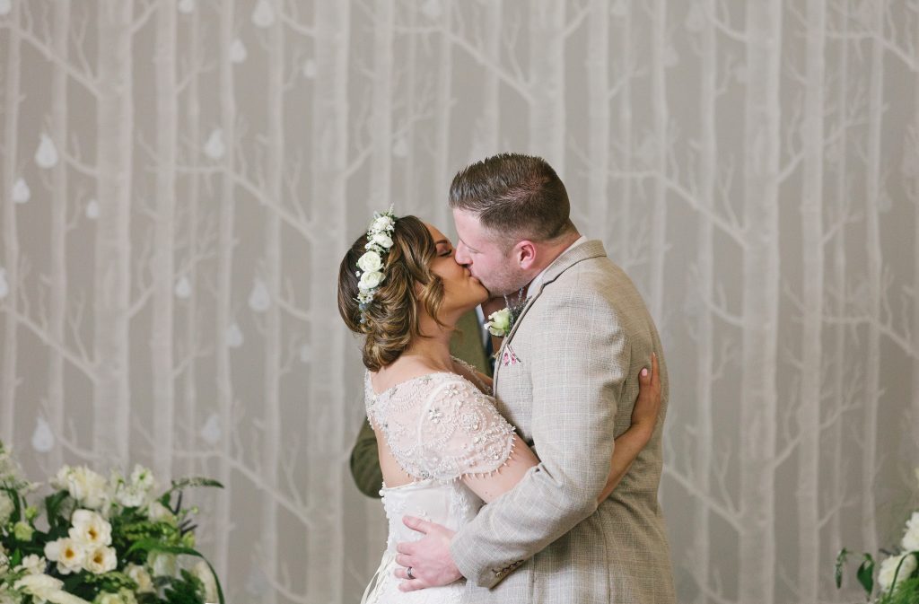 A Bride and Groom kiss after their Hampton Manor wedding ceremony