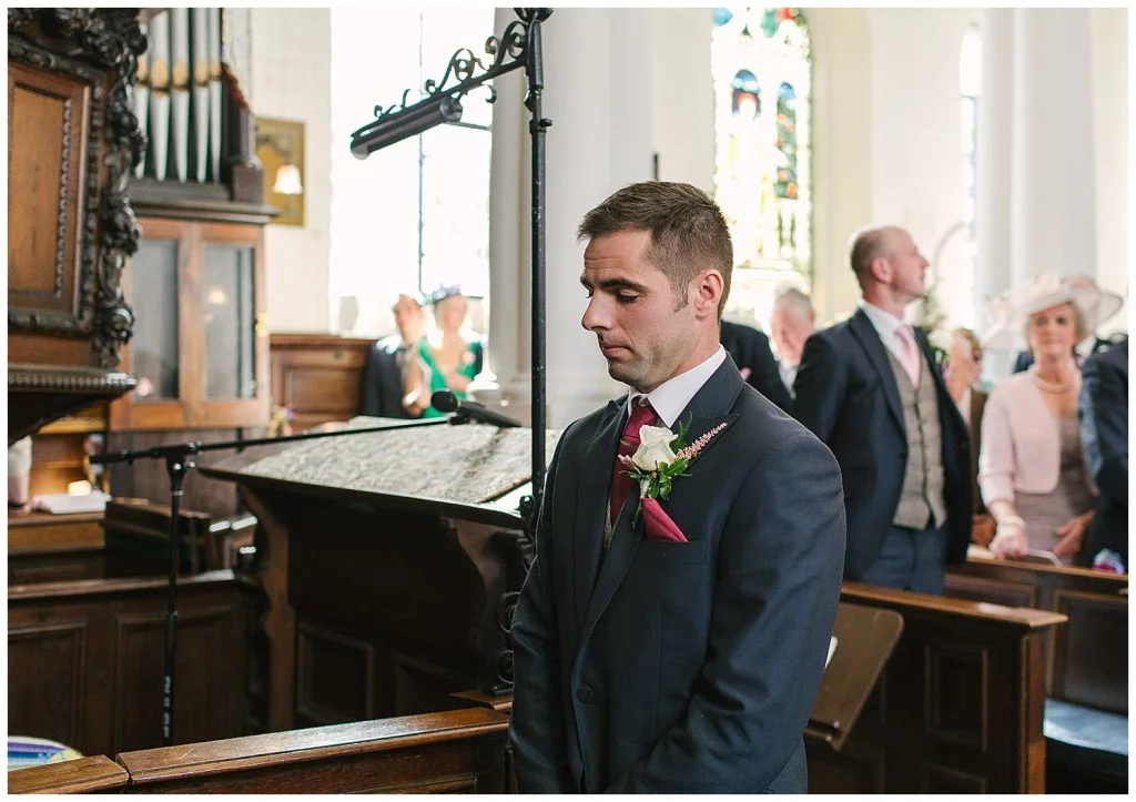 A Groom waiting for his Bride on their wedding day at Ingestre Church, Staffordshire