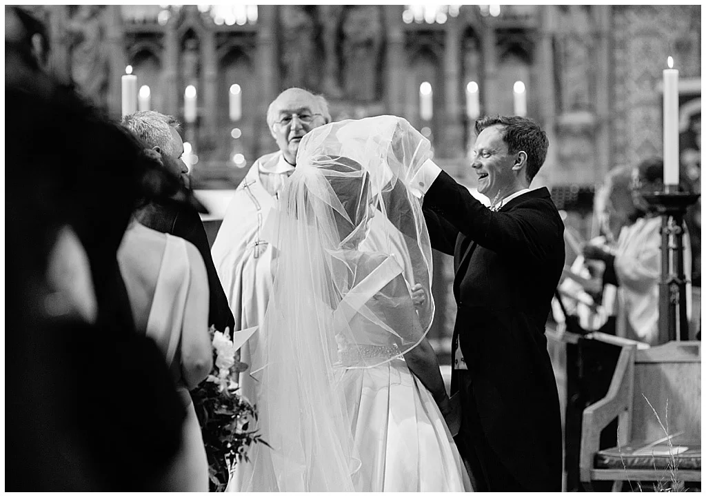 Groom lifts the Bride's veil