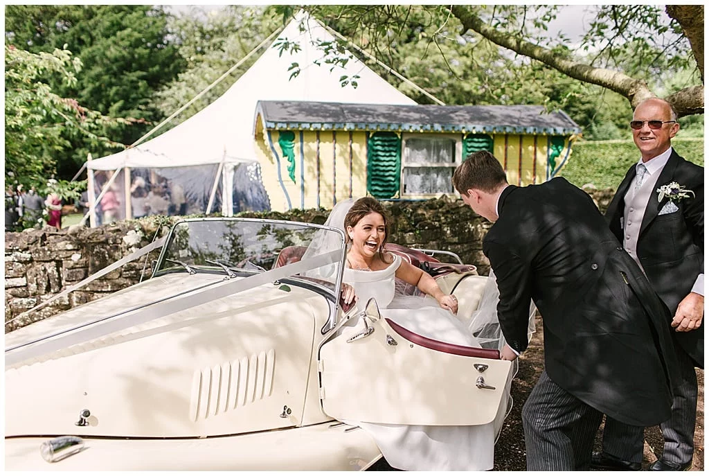 Classic Suzanne Neville Bride arriving in style | Marquee wedding at home
