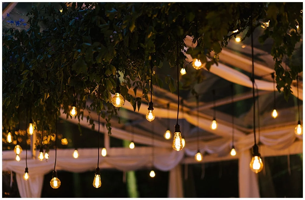 magical atmosphere in wedding marquee with hanging light bulbs