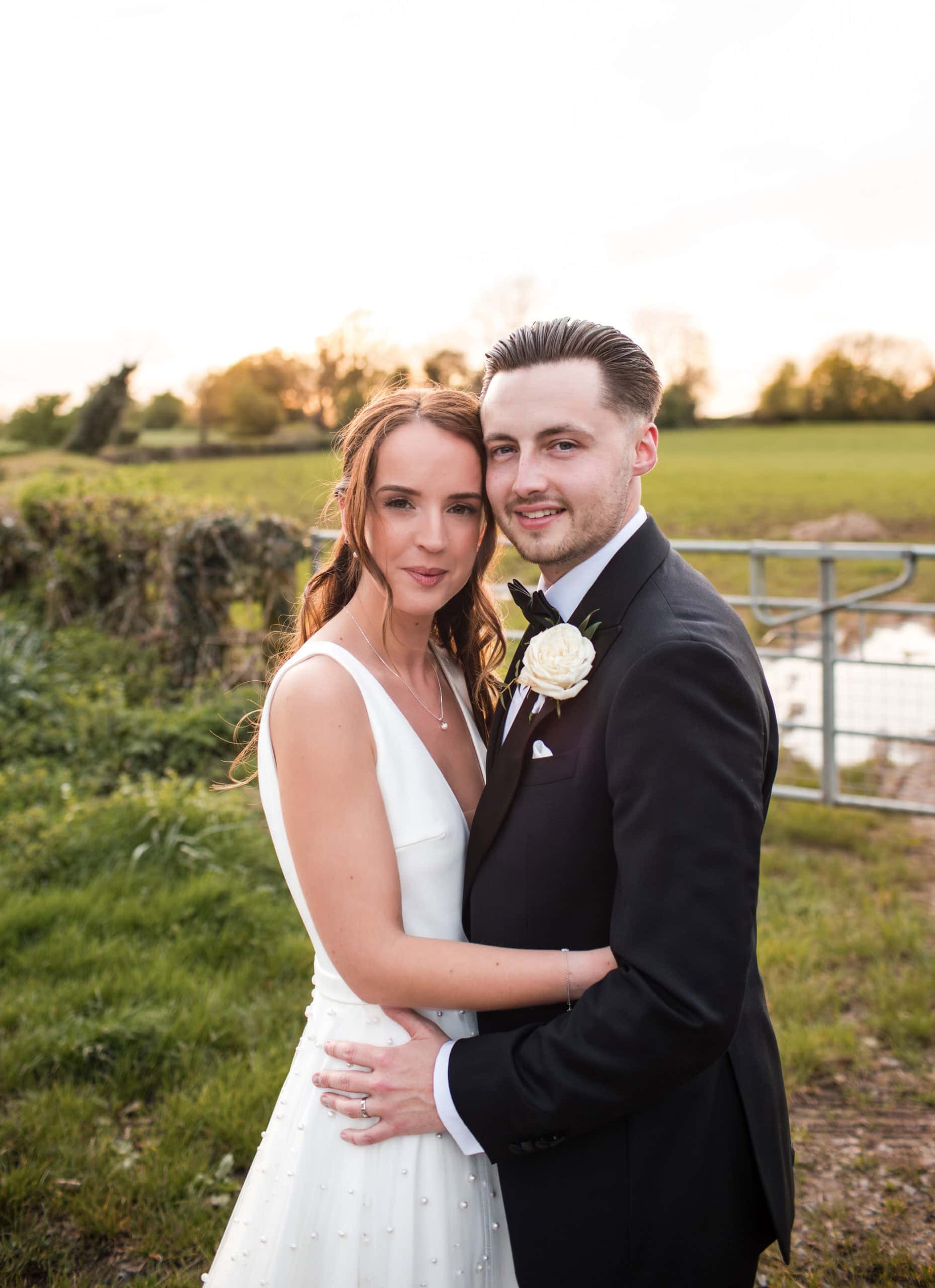 couple portrait at sunset in the countryside after it's rained