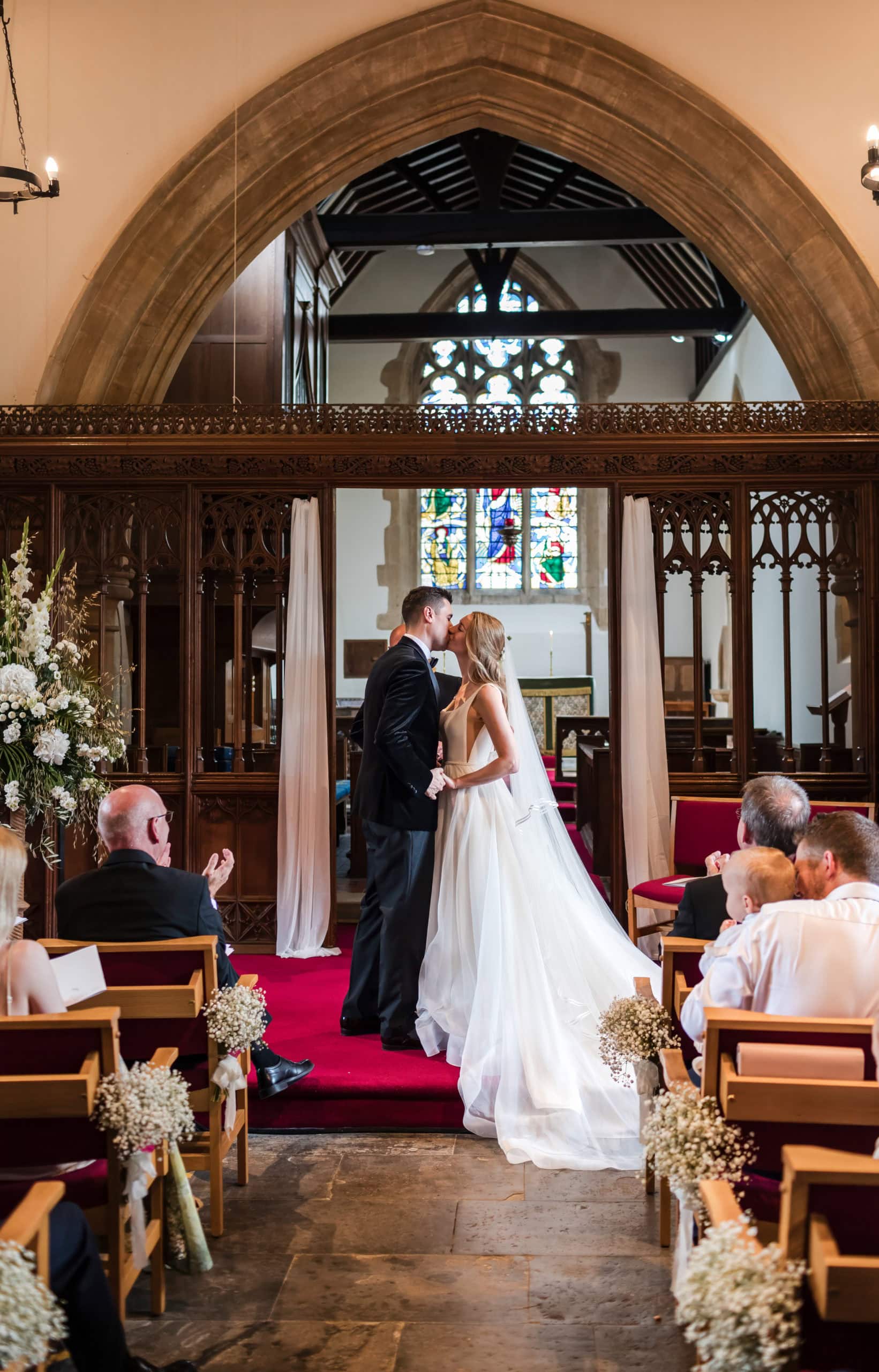 Newly married couple share a kiss inside Welford on Avon Church